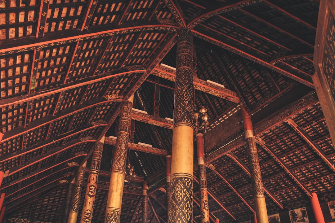 a-large-wooden-structure-with-columns-and-a-ceiling-l-7nxigpmxk
